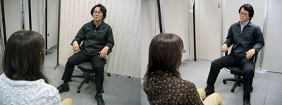 Hiroshi Ishiguro and Geminoid HI-1 talk to a participant